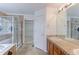 Bright bathroom featuring double sinks, tiled shower, and separate soaking tub at 2631 E 136Th Pl, Thornton, CO 80602