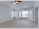 Spacious bedroom with neutral carpet, large windows and a ceiling fan at 2631 E 136Th Pl, Thornton, CO 80602