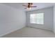 Well-lit bedroom with a ceiling fan and a window overlooking the green landscape at 2631 E 136Th Pl, Thornton, CO 80602