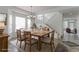 Dining room boasts a large table, a view of the staircase, and natural light from the large windows at 2631 E 136Th Pl, Thornton, CO 80602