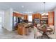 Well-lit kitchen features wood cabinets, granite countertops, stainless steel appliances, and a kitchen island with bar stool seating at 2631 E 136Th Pl, Thornton, CO 80602