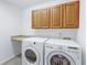Laundry room with tile floor, built in cabinets, countertop, and a washer and dryer at 2631 E 136Th Pl, Thornton, CO 80602