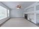 Bright and airy living room with a fireplace, built-in shelves, and large windows with nice view at 2631 E 136Th Pl, Thornton, CO 80602