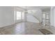 Bright living room boasting tiled floors, staircase, and ample natural light from large windows at 2631 E 136Th Pl, Thornton, CO 80602