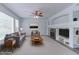 Bright living room with a ceiling fan, fireplace, and large windows that allow plenty of natural light to enter at 2631 E 136Th Pl, Thornton, CO 80602