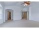 Spacious main bedroom with neutral carpet, ceiling fan, and open doorways at 2631 E 136Th Pl, Thornton, CO 80602