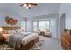 Spacious main bedroom with a bay window, soft carpet, and rustic wood furniture at 2631 E 136Th Pl, Thornton, CO 80602