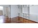 Office space featuring hardwood floors, a window, and built-in white shelving and cabinets at 2631 E 136Th Pl, Thornton, CO 80602