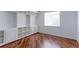 Office featuring hardwood floors, natural light, and built in shelving at 2631 E 136Th Pl, Thornton, CO 80602