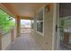 Charming porch with wood decking, railings, and view of neighborhood and green trees at 2631 E 136Th Pl, Thornton, CO 80602