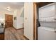 Hallway view with wooden door and stacked washer and dryer at 505 S Main St # 2207, Breckenridge, CO 80424