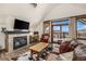 Cozy living room with fireplace, wood floors, and balcony access at 505 S Main St # 2207, Breckenridge, CO 80424