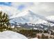 Snow-covered mountain with ski tracks surrounded by evergreen trees on a sunny day at 505 S Main St # 2207, Breckenridge, CO 80424