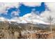 Beautiful view of snow capped mountains behind tree tops and rooftops at 505 S Main St # 2207, Breckenridge, CO 80424