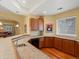Basement bar featuring hardwood floors, wooden cabinets, and tile countertops at 5700 S Benton Cir, Littleton, CO 80123