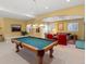 Basement entertainment area featuring pool table and comfortable seating at 5700 S Benton Cir, Littleton, CO 80123