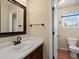 Small bathroom featuring a single sink vanity and a toilet, ideal for guest use at 5700 S Benton Cir, Littleton, CO 80123