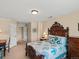 Comfortable bedroom showcasing a vintage bed frame and a view into the hallway at 5700 S Benton Cir, Littleton, CO 80123