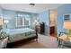 Light-filled bedroom with blue walls and en-suite bathroom, providing a private retreat at 5700 S Benton Cir, Littleton, CO 80123