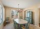 Inviting dining room featuring a decorative chandelier, and a charming green cabinet with glass doors at 5700 S Benton Cir, Littleton, CO 80123