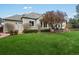 Landscaped yard with mature trees and patio dining at this beautiful home at 5700 S Benton Cir, Littleton, CO 80123