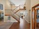 Elegant foyer with a grand staircase, hardwood floors, and soaring ceilings at 5700 S Benton Cir, Littleton, CO 80123