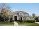 Charming two-story home with a beautiful lawn, shrubs, and a well-lit entryway at 5700 S Benton Cir, Littleton, CO 80123