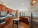 Gourmet kitchen features stainless appliances, center island, and light-filled breakfast nook with a bay window at 5700 S Benton Cir, Littleton, CO 80123