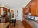 This kitchen has wood cabinets, stainless appliances, and a large center island with granite countertops at 5700 S Benton Cir, Littleton, CO 80123