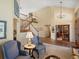 Open-concept living room featuring a grand staircase, soaring ceilings, and an elegant chandelier at 5700 S Benton Cir, Littleton, CO 80123