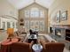 This is a spacious living room with a fireplace, vaulted ceilings, and large windows that fill the space with natural light at 5700 S Benton Cir, Littleton, CO 80123