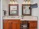 Beautiful bathroom with a dual sink vanity, granite counters, and framed mirrors at 5700 S Benton Cir, Littleton, CO 80123