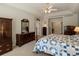 Spacious main bedroom with natural light, dresser, armoire, and connecting doors at 5700 S Benton Cir, Littleton, CO 80123
