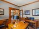 Elegant home office featuring wood trim, glass French doors, and a view to the staircase at 5700 S Benton Cir, Littleton, CO 80123