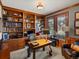Comfortable home office with custom built-in shelving and lots of natural light at 5700 S Benton Cir, Littleton, CO 80123