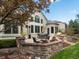Back patio and landscaped yard with stone retaining wall and dining area at 5700 S Benton Cir, Littleton, CO 80123