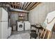 Unfinished basement area with washer, dryer, and exposed ceiling beams at 6240 Everett Ct # F, Arvada, CO 80004