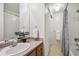 Clean bathroom with a shower/tub combo, linen closet, and wooden vanity at 6240 Everett Ct # F, Arvada, CO 80004
