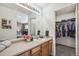 Bright and airy bathroom with wooden cabinets, a spacious vanity and walk in closet at 6240 Everett Ct # F, Arvada, CO 80004