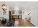 Entryway, dining area, and kitchen with hardwood floors with view into the living room at 6240 Everett Ct # F, Arvada, CO 80004