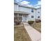 Well maintained townhome showcasing a concrete walkway and manicured lawn at 6240 Everett Ct # F, Arvada, CO 80004