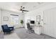 Bright home office featuring modern desk, fan, large window, and sitting area at 6240 Everett Ct # F, Arvada, CO 80004