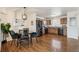 Open kitchen and dining area with hardwood floors and modern stainless steel appliances at 6240 Everett Ct # F, Arvada, CO 80004