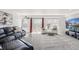 Bright living room with large windows, balcony access, and comfortable furnishings at 6240 Everett Ct # F, Arvada, CO 80004