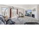 Sunny living room with large windows, balcony access, a modern fireplace, and contemporary furnishings at 6240 Everett Ct # F, Arvada, CO 80004