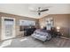 A serene primary bedroom with plush bedding, ceiling fan and balcony access at 6240 Everett Ct # F, Arvada, CO 80004