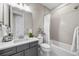 Bathroom featuring modern finishes, a tub-shower combo, and a gray vanity at 4265 E Iliff Ave # 1, Denver, CO 80222