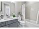 Modern bathroom featuring gray vanity, white countertop, and shower with stylish gray herringbone tile surround at 4265 E Iliff Ave # 1, Denver, CO 80222