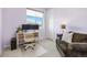 Bright bedroom with a cozy seating area, desk, and a large window offering natural light at 4265 E Iliff Ave # 1, Denver, CO 80222
