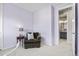Comfortable bedroom featuring plush armchair, side table, and doorway leading to an ensuite bathroom at 4265 E Iliff Ave # 1, Denver, CO 80222